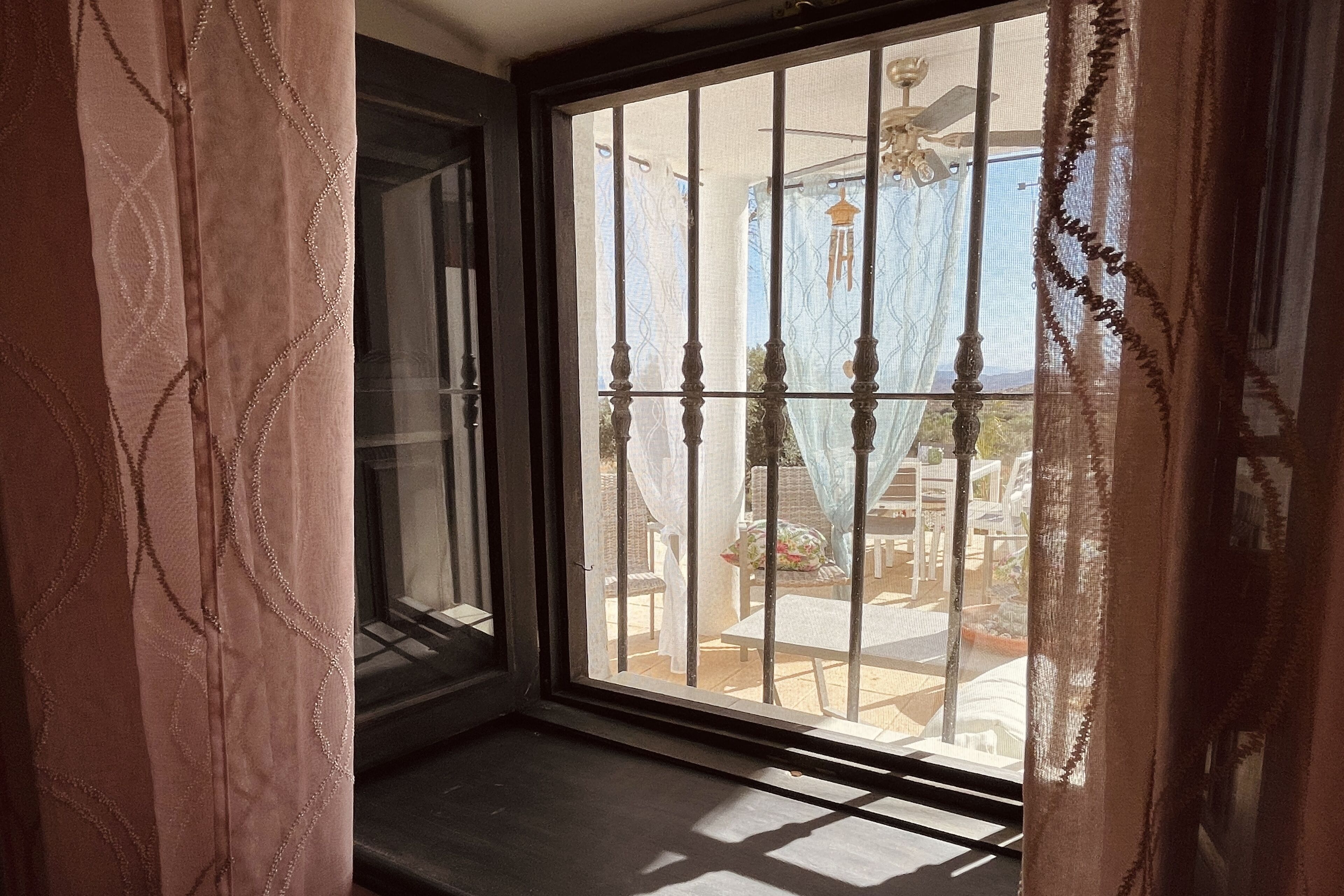 A room with a sliding glass door leading to an outdoor patio area.