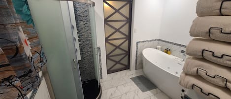 Shower, jetted bath, towels, soap