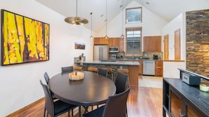 A modern kitchen with a central island, wooden cabinets, and pendant lighting. - OwlMeadows16 3 Bedroom/3 Bath Condo (Telluride)