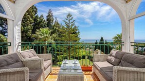 A balcony with wicker furniture and a view of the sea. - Seaview Balcony by Costarentals - Ref 203 (Mijas)