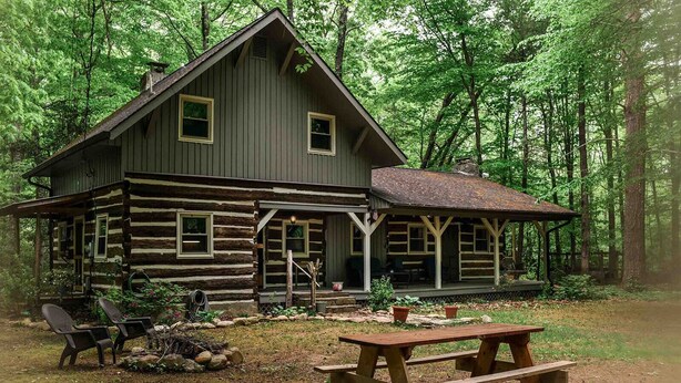 A rustic log cabin with a porch and a picnic table in a forest setting. - Hikers Retreat in the Linville Gorge Forest (Nebo)