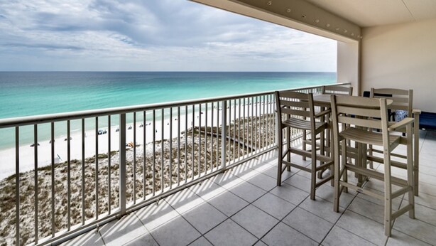 A balcony with a view of a beach and ocean. - Navarre Beach Regency 705 - Nama' Stay At The Beach (Navarre)