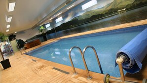 An indoor swimming pool with a wooden deck, metal handrails, and a mural of a lake and mountains on the wall. - Quinta do Passal (Pacos De Ferreira)