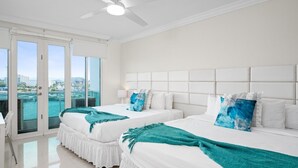 A hotel room with two beds, a ceiling fan, and a view of the city. - Panoramic Lagoon Studio · Water Backup (San Juan)