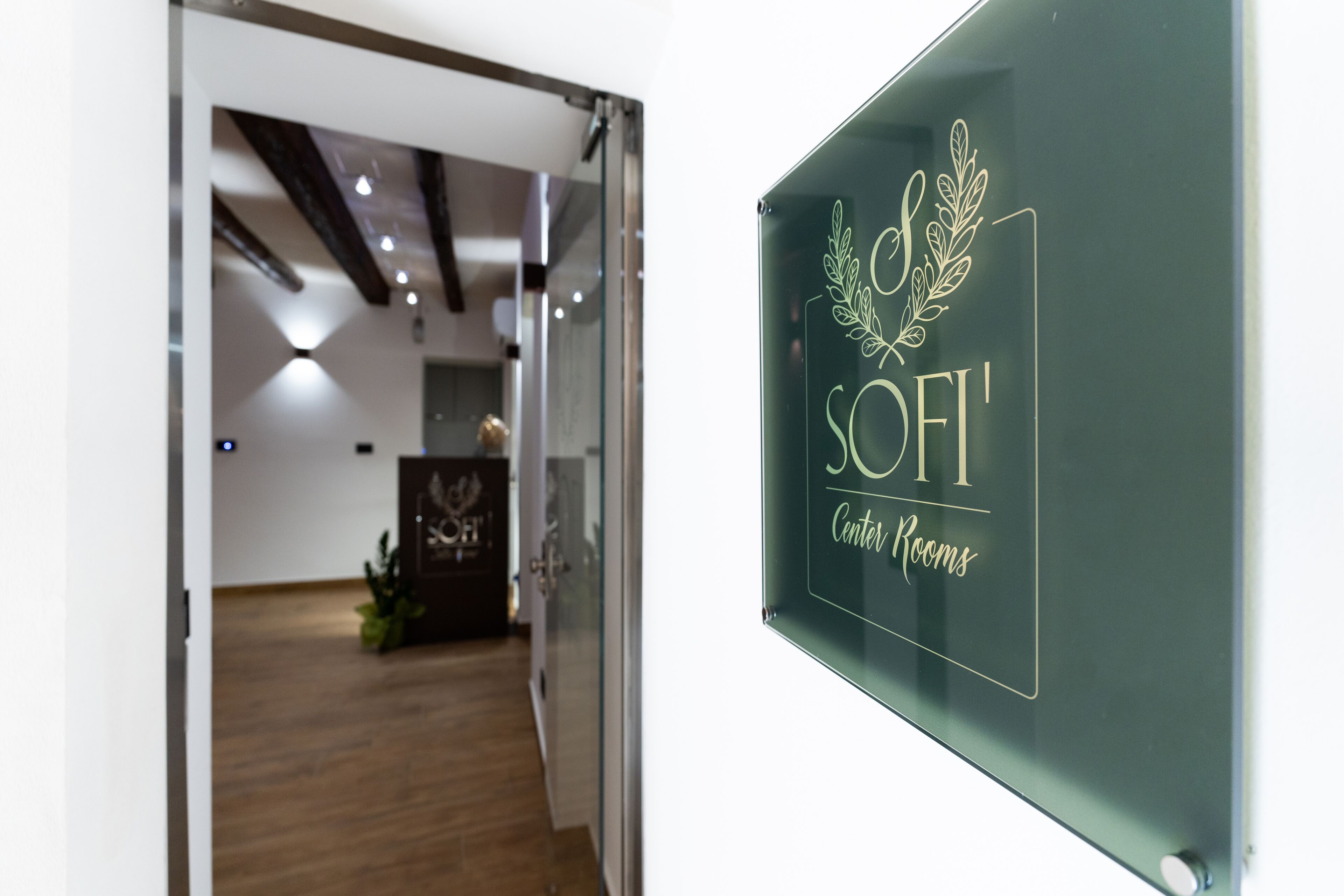 A glass door with a sign reading "SOFI Center Rooms".