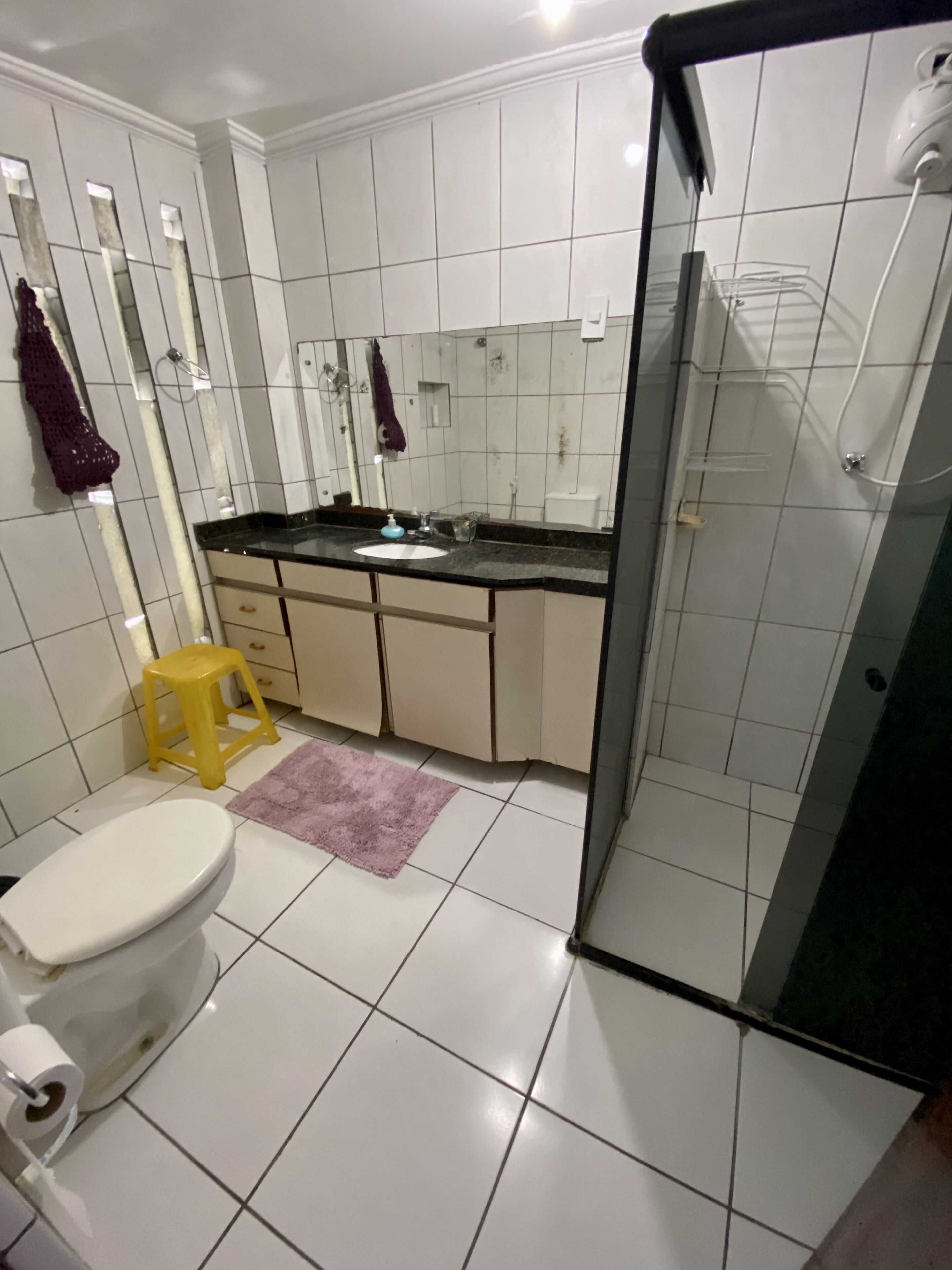 A bathroom with a toilet, sink, and shower.