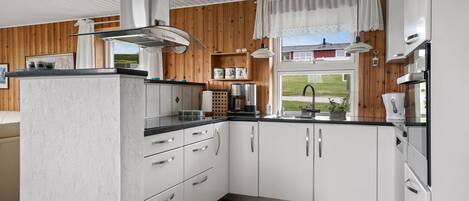 Fridge, stovetop, dishwasher, coffee/tea maker