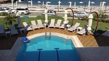 Seasonal outdoor pool, open 9:00 AM to 9:30 AM, pool umbrellas