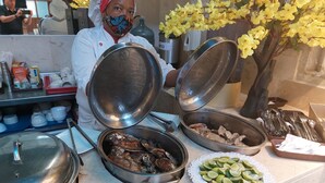 A buffet setup with various dishes, including fish and lime slices. - Hotel Toledo FL (Cartagena)