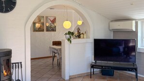 A living room with a fireplace, a TV, and a dining area. - Gorgeous home in Hemmet with WiFi (Hemmet)