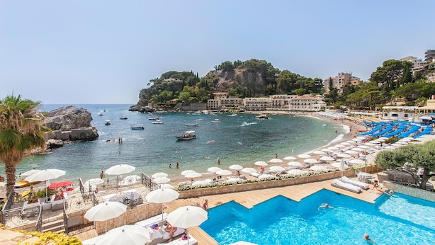 A coastal resort with a swimming pool, beach umbrellas, and boats on the water. - Gorgeous home in Roccalumera with WiFi (Roccalumera)