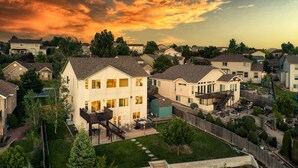 A residential neighborhood with houses, a backyard with a hot tub, and a wooden deck. - Creekside Mountain View Retreat, Hot Tub, Sleeps 14, 6 Kings, 5 bathrooms (Colorado Springs)