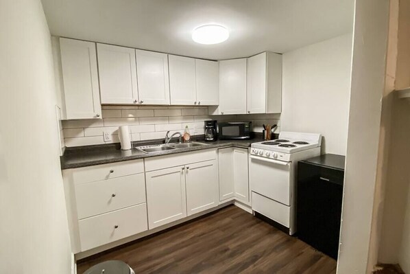 Fridge, microwave, stovetop, coffee/tea maker
