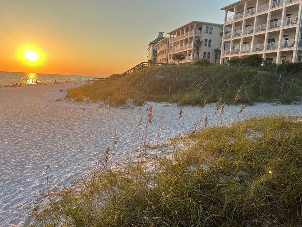 A beachfront hotel with multiple balconies overlooking the ocean.