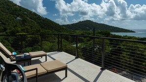 A balcony with a view of a mountainous landscape and the sea. - Tropical Seabreeze- Pool and back up power/solar (Cruz Bay)
