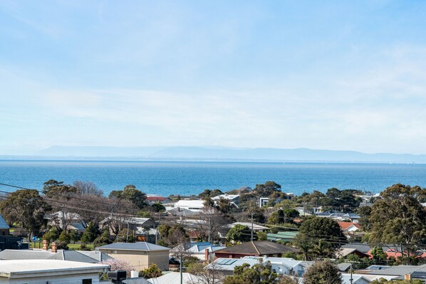 A coastal residential area with houses and a view of the sea. - Beautiful Victorian Home With Amazing Views and Centrally Located (Portarlington)