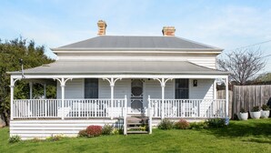 A two-story house with a porch, a front door, and a chimney. - Beautiful Victorian Home With Amazing Views and Centrally Located (Portarlington)