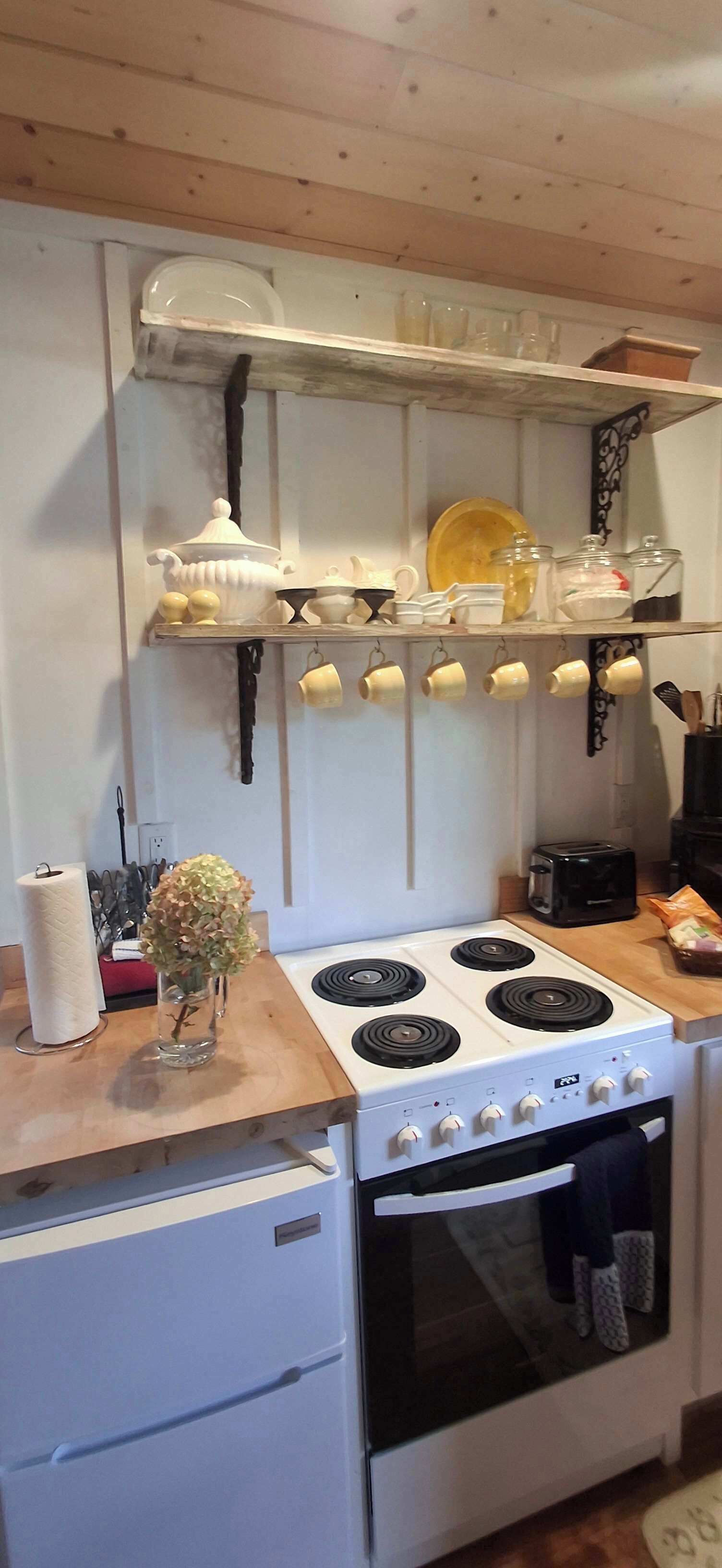 Coffee/tea maker, fridge, stovetop, cookware/dishes/utensils