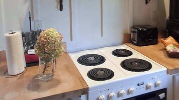 Coffee/tea maker, fridge, stovetop, cookware/dishes/utensils