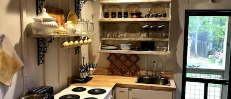 Coffee/tea maker, fridge, stovetop, cookware/dishes/utensils