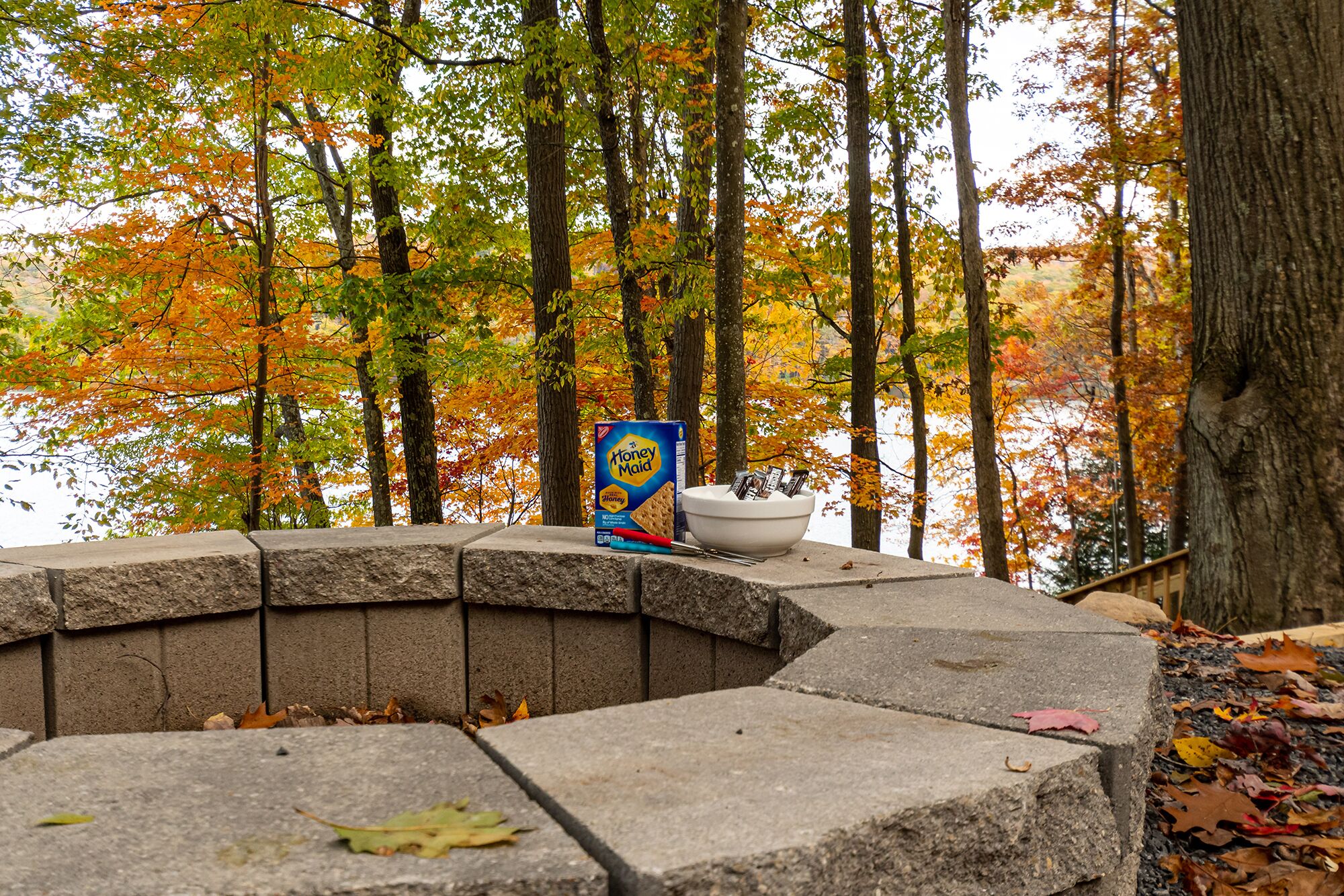 A stone bench with a Honey Maid cereal box and utensils.