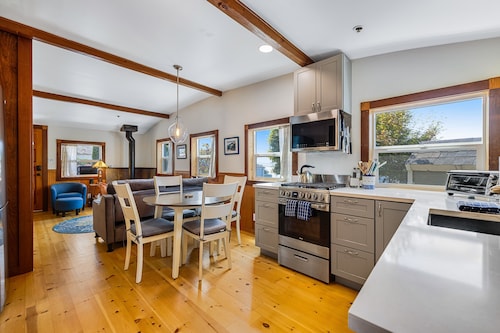 Updated, dog-friendly cottage with bay views, wraparound deck & EV charger