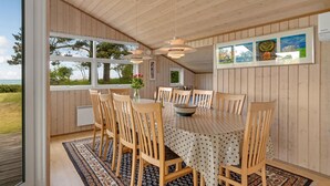 A wooden interior with a dining table, chairs, and a view of the outdoors. - Gorgeous home in Allingåbro with WiFi (Allingåbro)