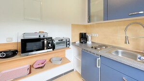 A compact kitchen with a microwave, toaster, coffee maker, and a sink. - "Experience unforgettable days in the "Engel" vacation bungalow on the Baltic Sea!" - To (Ückeritz)