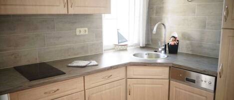 Fridge, stovetop, dishwasher, coffee/tea maker