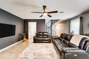 TV, fireplace - Stylish loft-style condo with private patio, central AC, & W/D - dog-friendly (Humble)