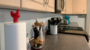 A kitchen with light wooden cabinets, a stainless steel refrigerator, and a granite countertop. - Cozy Basement Suite close to Downtown (Edmonton)