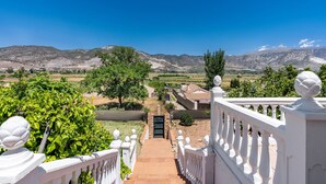 A staircase leading to a terrace with a view of mountains and a garden. - Holiday Home 'Ladera De Los Molinos' with Mountain View, Pool, Garden & Wi-Fi (Padul)