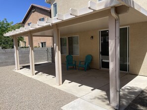 Relax under the pergola, surrounded by a peaceful outdoor space with a comfortable seating area.