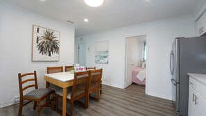 Enjoy a stylish space with a dining table, refrigerator, and kitchenette area.