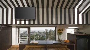 Una cucina moderna con un'ampia finestra, una televisione a schermo piatto e un frigorifero.