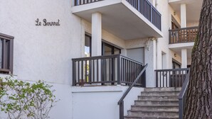 A multi-story building with a sign reading "Le Boutre". It features a staircase with a black railing leading to an upper floor. - Le Bourret by Interhome (Hossegor)