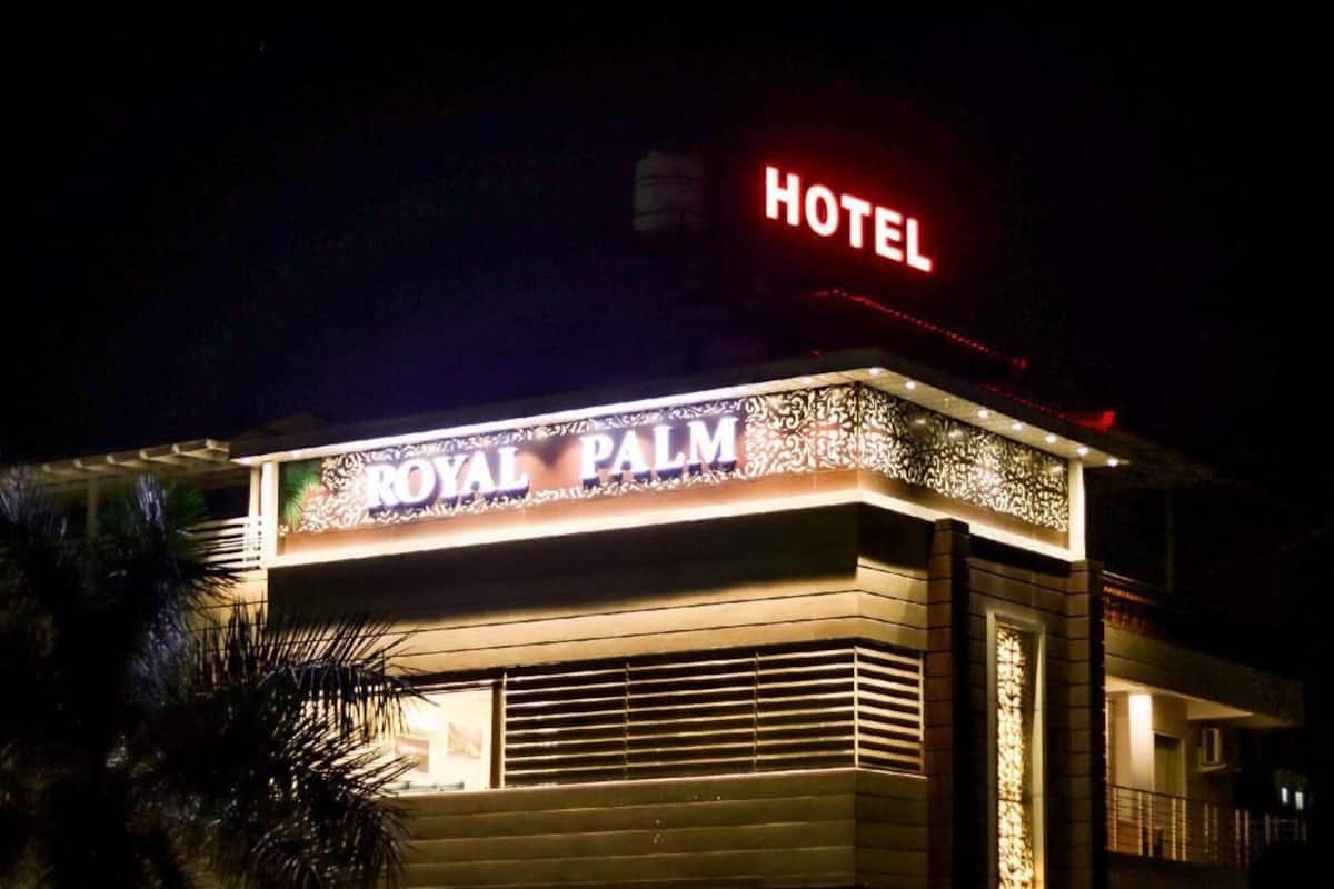 A hotel named 'Royal Palm' with a prominent 'HOTEL' sign at the top.