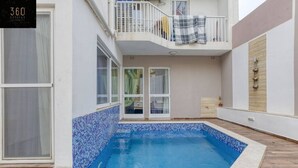 A residential property with a swimming pool, a balcony with a railing, and a door leading to a covered area. - Central 4BR, massive APT with private POOL & BBQ (Is-Swieqi)