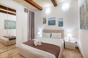 1 bedroom, desk, iron/ironing board, travel crib