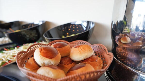 A basket of dinner rolls and a bowl of soup. - BELLEZZA HOTEL (Istanbul)