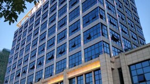 A multi-story building with a modern architectural design, featuring a series of large windows and a prominent entrance area. - Bohao Hotel (Zunyi)