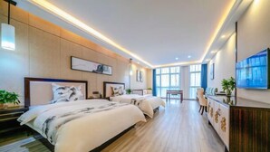 A modern hotel room with two beds, a desk, and a TV. - Bohao Hotel (Zunyi)