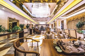 A spacious lobby with a checkered floor, a central seating area, and a chandelier. - Bohao Hotel (Zunyi)