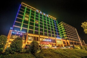 A multi-story hotel with a prominent entrance and a well-lit facade. - Bohao Hotel (Zunyi)
