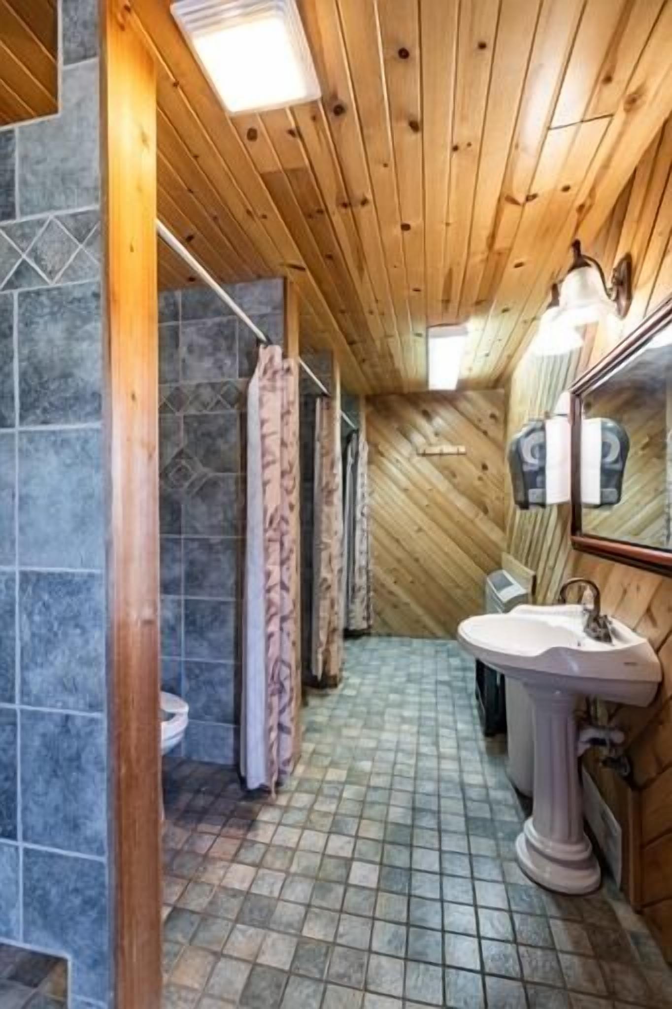 Shared bunkhouse with individual private rooms with separate toilets and showers for men and women