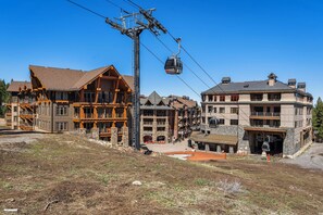 A ski resort with a cable car system, wooden buildings, and a stone structure. - 2 Queens | Gondola Views | Rec Center Access | Near Village & Trails (Truckee)