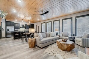 Relax in this stylish living area with a sofa, coffee table, and dining space.