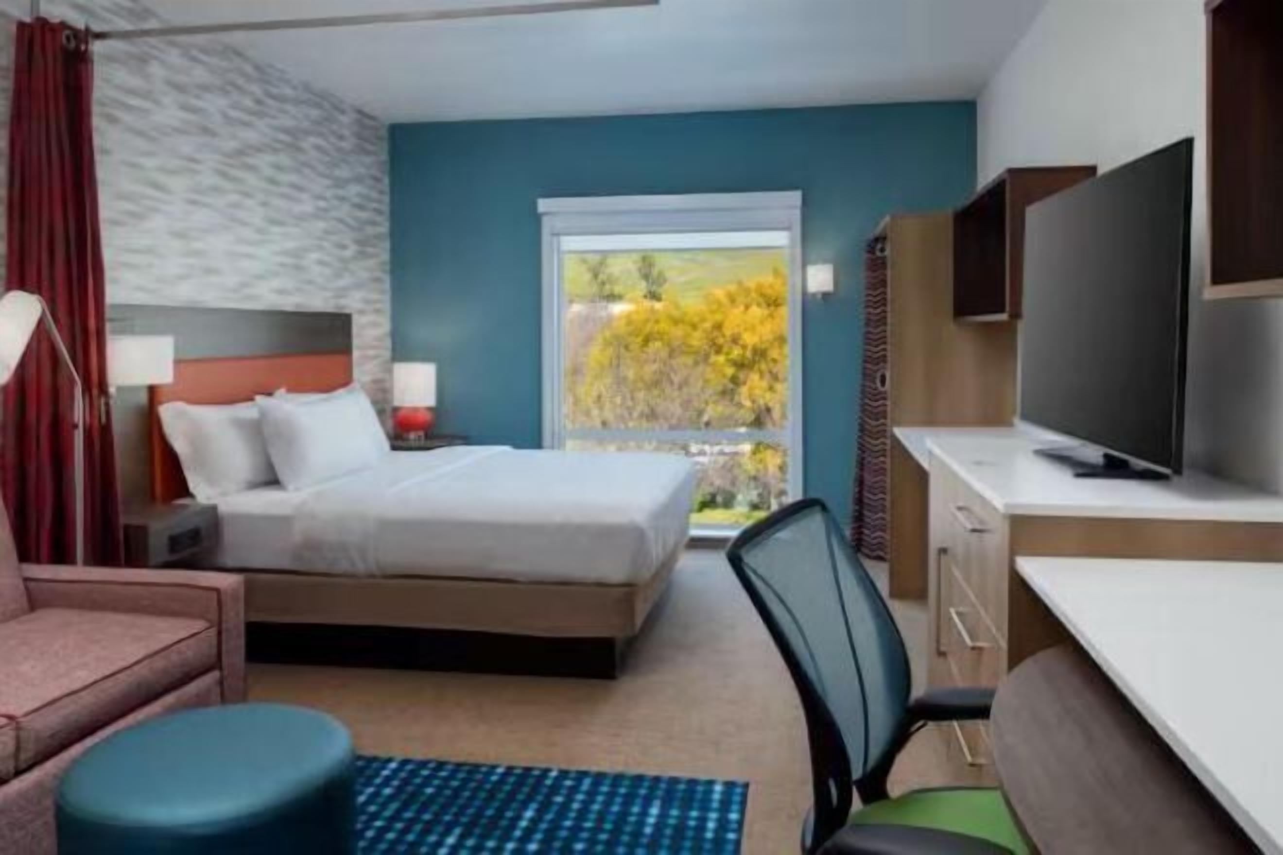 Colchones con acolchado adicional y tabla de planchar con plancha