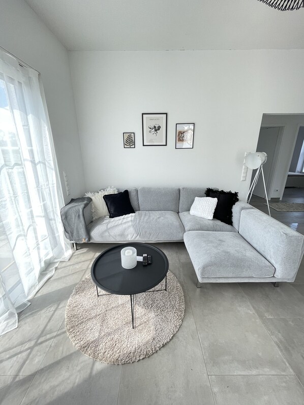 Relax in this stylish living room with a comfortable sofa, coffee table, and artwork on the wall.