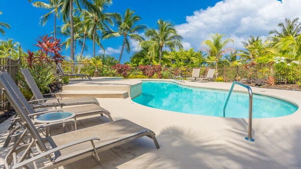 A pool area with lounge chairs and palm trees. - Aloha Condos, Keauhou Resort, Condo 108, Ocean View, AC (Kailua Kona)